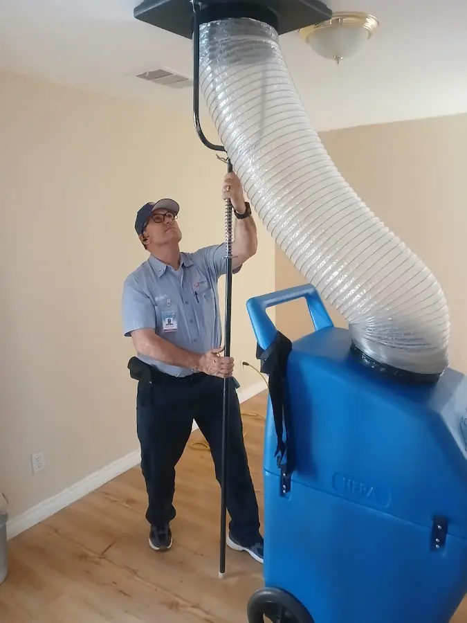 Furnace Tune-Up technician using HEPA equipment in Felida